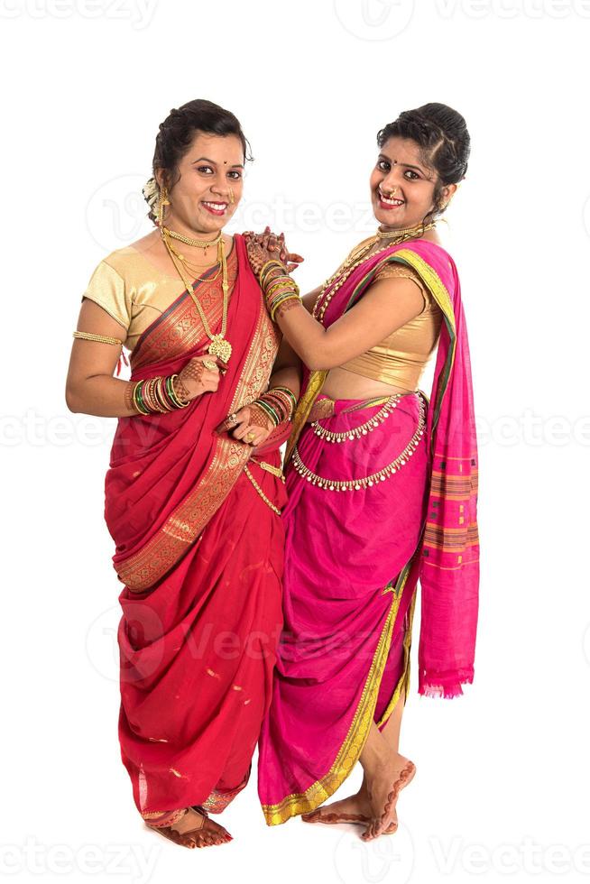 Traditional Beautiful Indian young girls in saree posing on white background photo