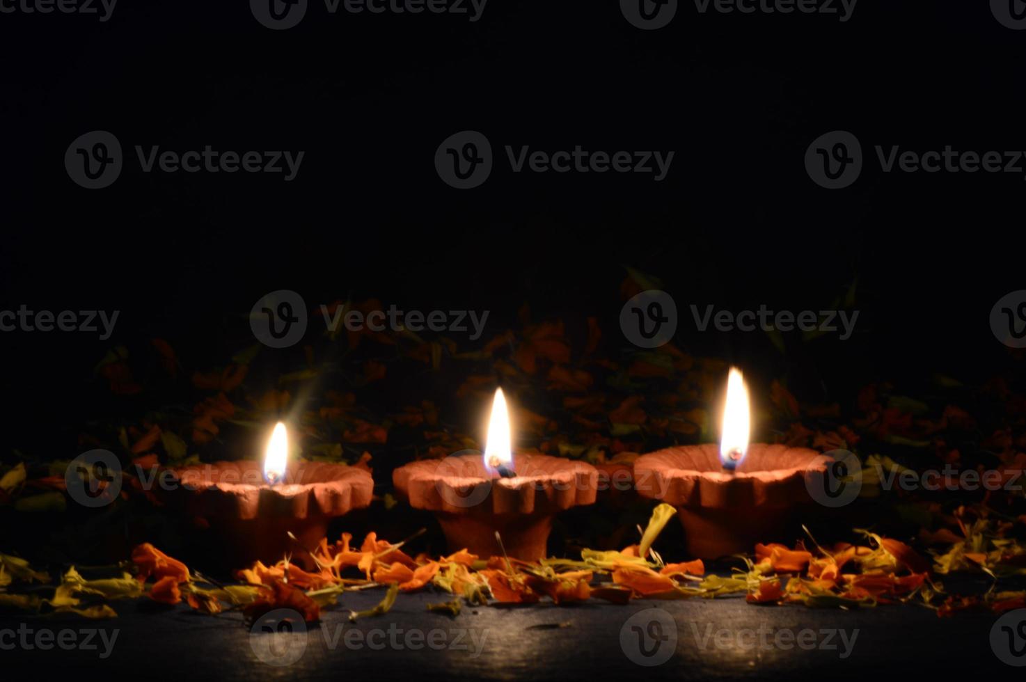 Clay diya lamps lit during Diwali Celebration. Greetings Card Design Indian Hindu Light Festival called Diwali photo