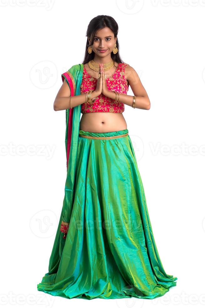 Beautiful Indian girl with welcome expression inviting, greeting Namaste photo