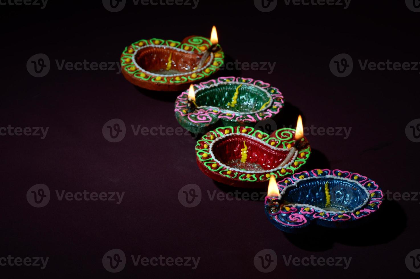 Colorful clay Diya Lantern lamps lit during Diwali celebration. Greetings Card Design Indian Hindu Light Festival called Diwali. photo