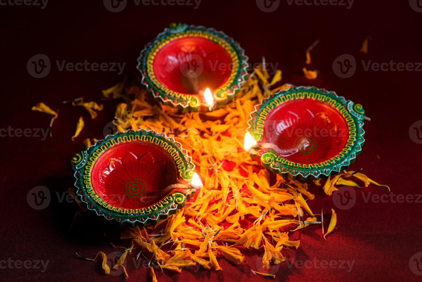 Happy Diwali - Clay Diya lamps lit during Diwali celebration. Greetings Card Design of Indian Hindu Light Festival called Diwali photo