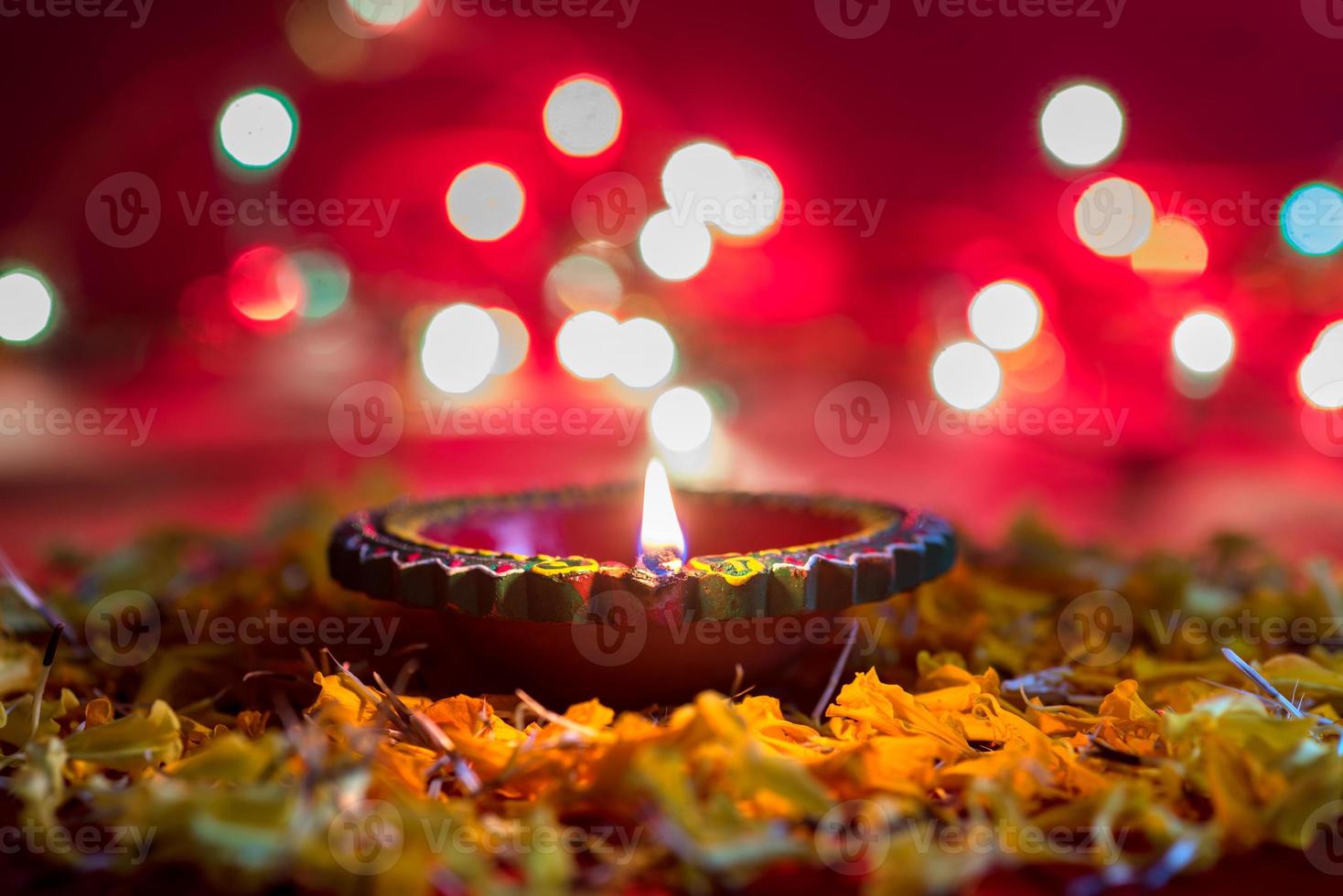 Happy Diwali - Clay Diya lamps lit during Diwali celebration. Greetings Card Design of Indian Hindu Light Festival called Diwali photo