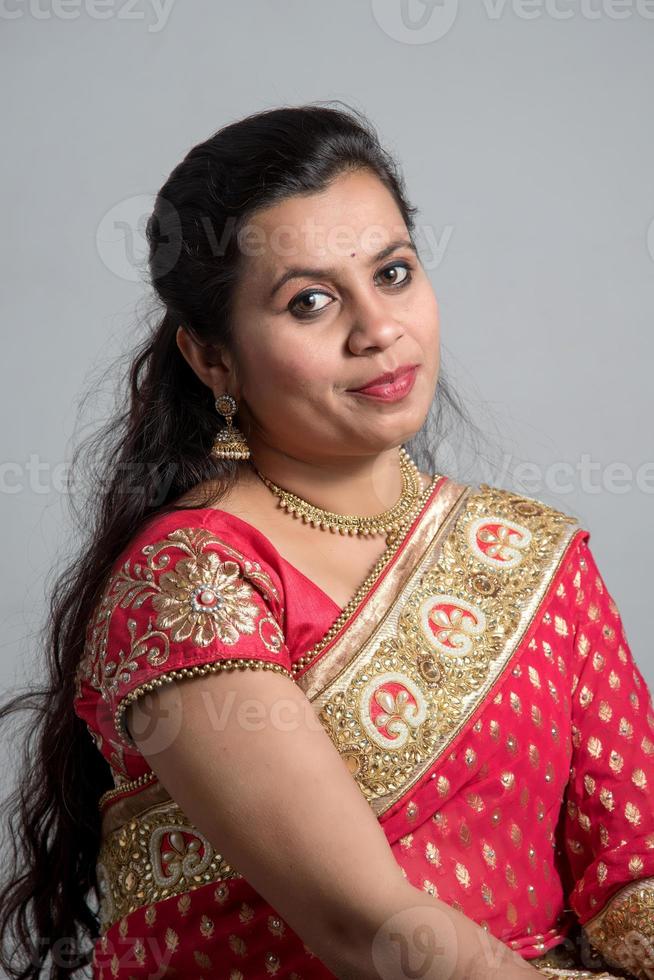 Beautiful young girl posing in Indian traditional saree on white background. photo