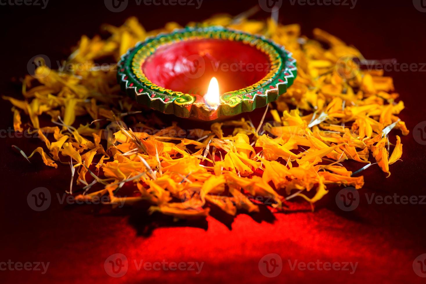 Happy Diwali - Clay Diya lamps lit during Diwali celebration. Greetings Card Design of Indian Hindu Light Festival called Diwali photo