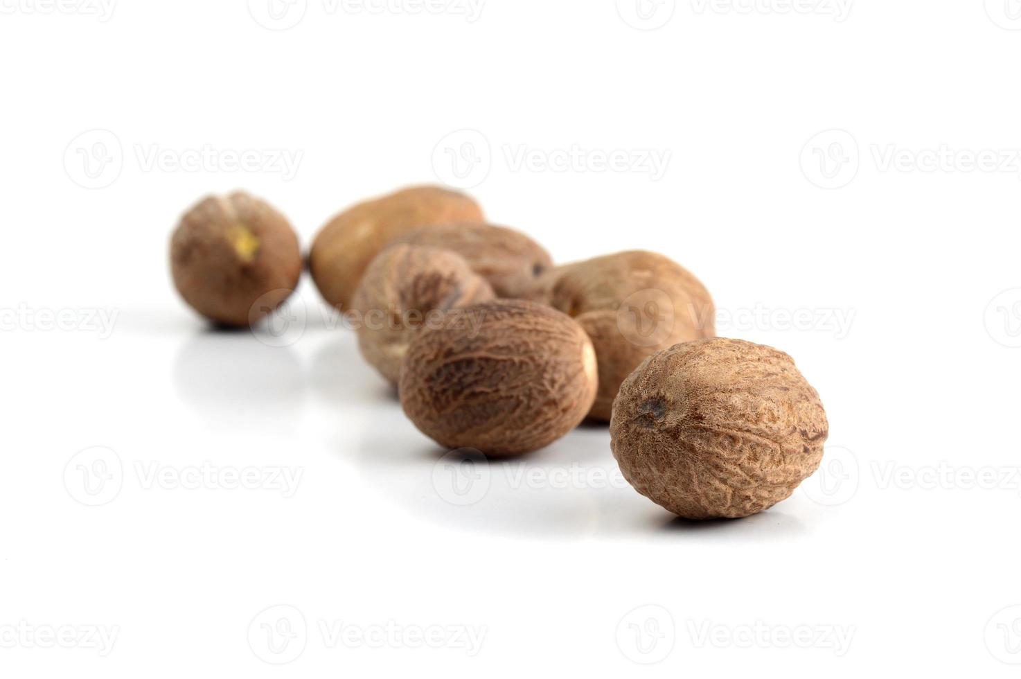 Nutmeg isolated on white background. Close up. photo