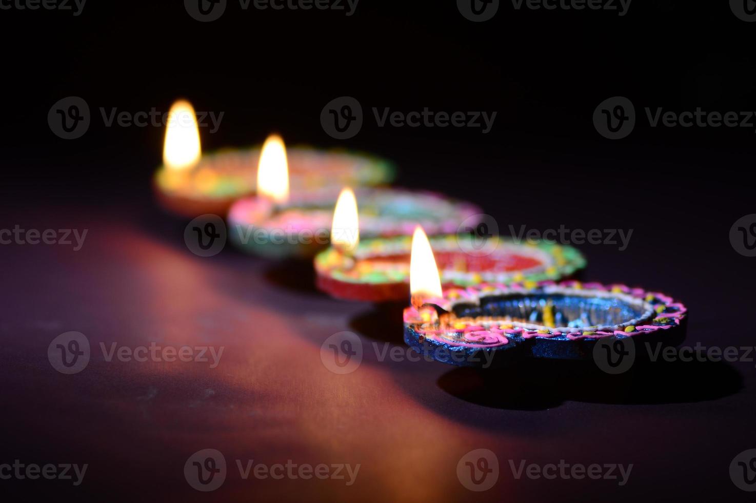 Clay diya lamps lit during diwali celebration. Greetings Card Design Indian Hindu Light Festival called Diwali photo