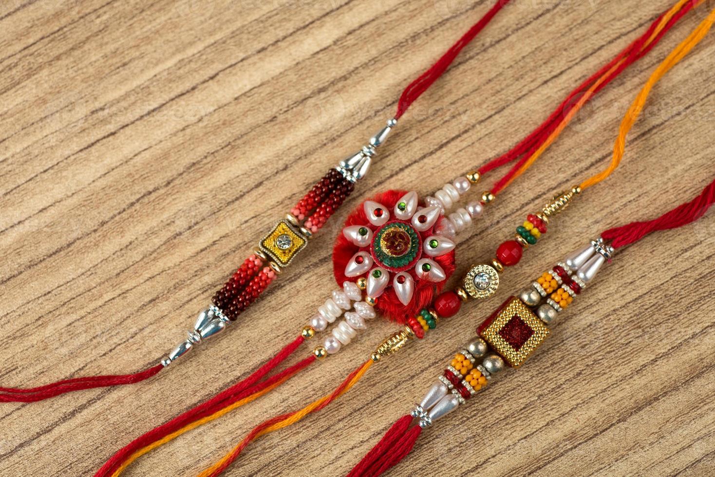 Raksha Bandhan background with an elegant Rakhi . A traditional Indian wrist band which is a symbol of love between Brothers and Sisters. photo