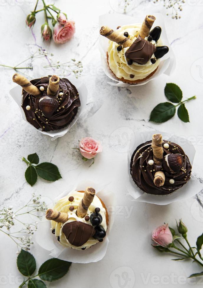 Chocolate cupcakes on white wooden background photo