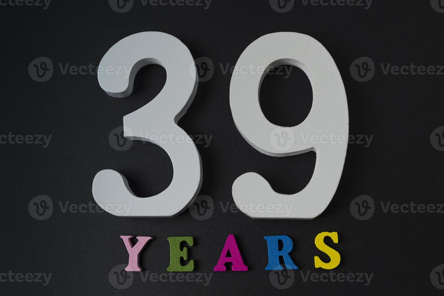 Letters and numbers thirty-nine years on a black background. photo
