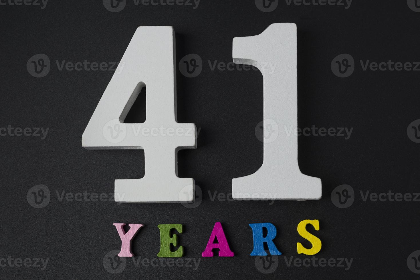 Letters and numbers forty-one years on a black background. photo