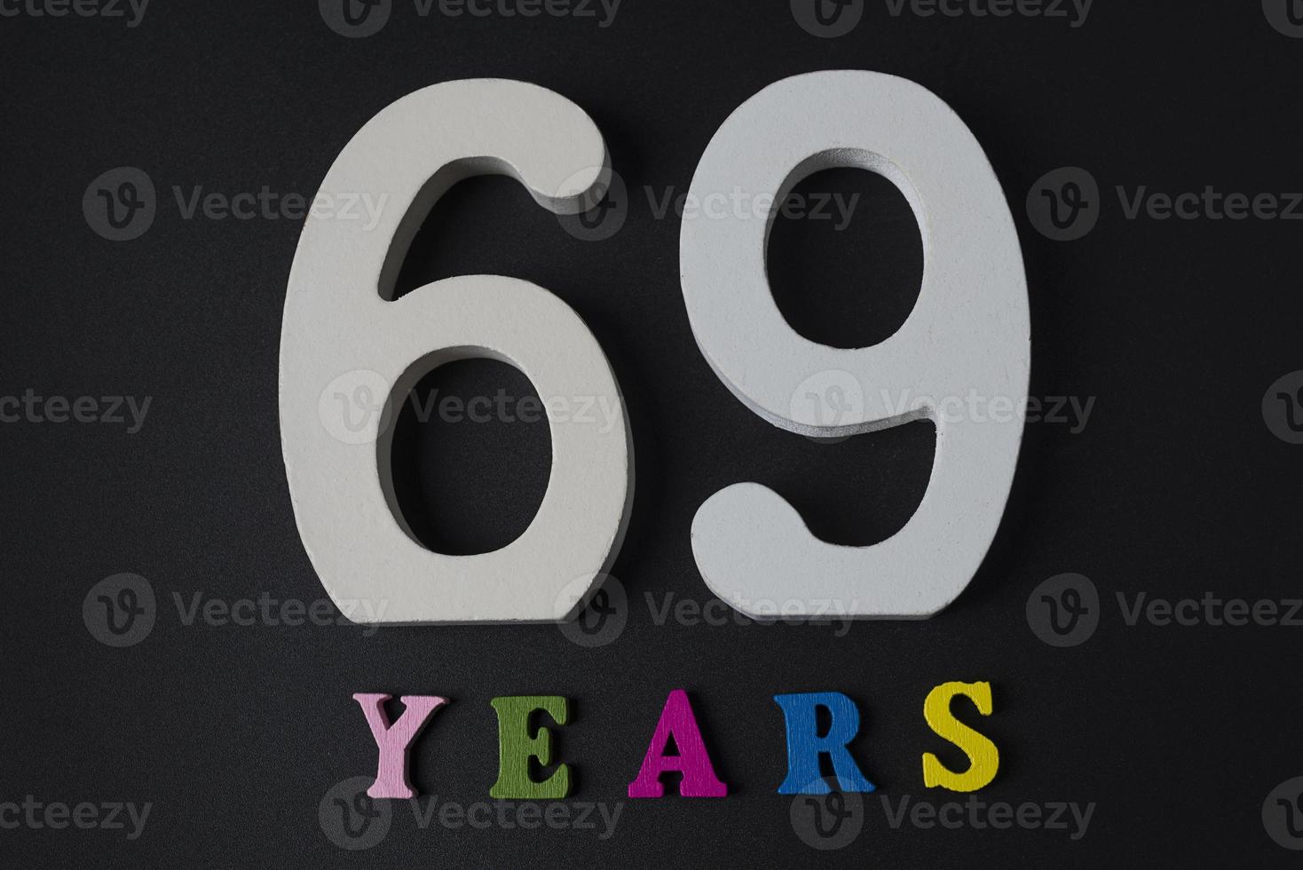 Letters and numbers-sixty-nine on a black background. photo