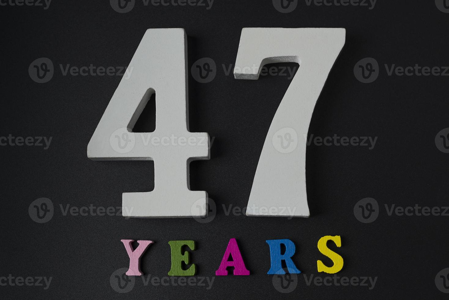 Letters and numbers-forty-seven on a black background. photo