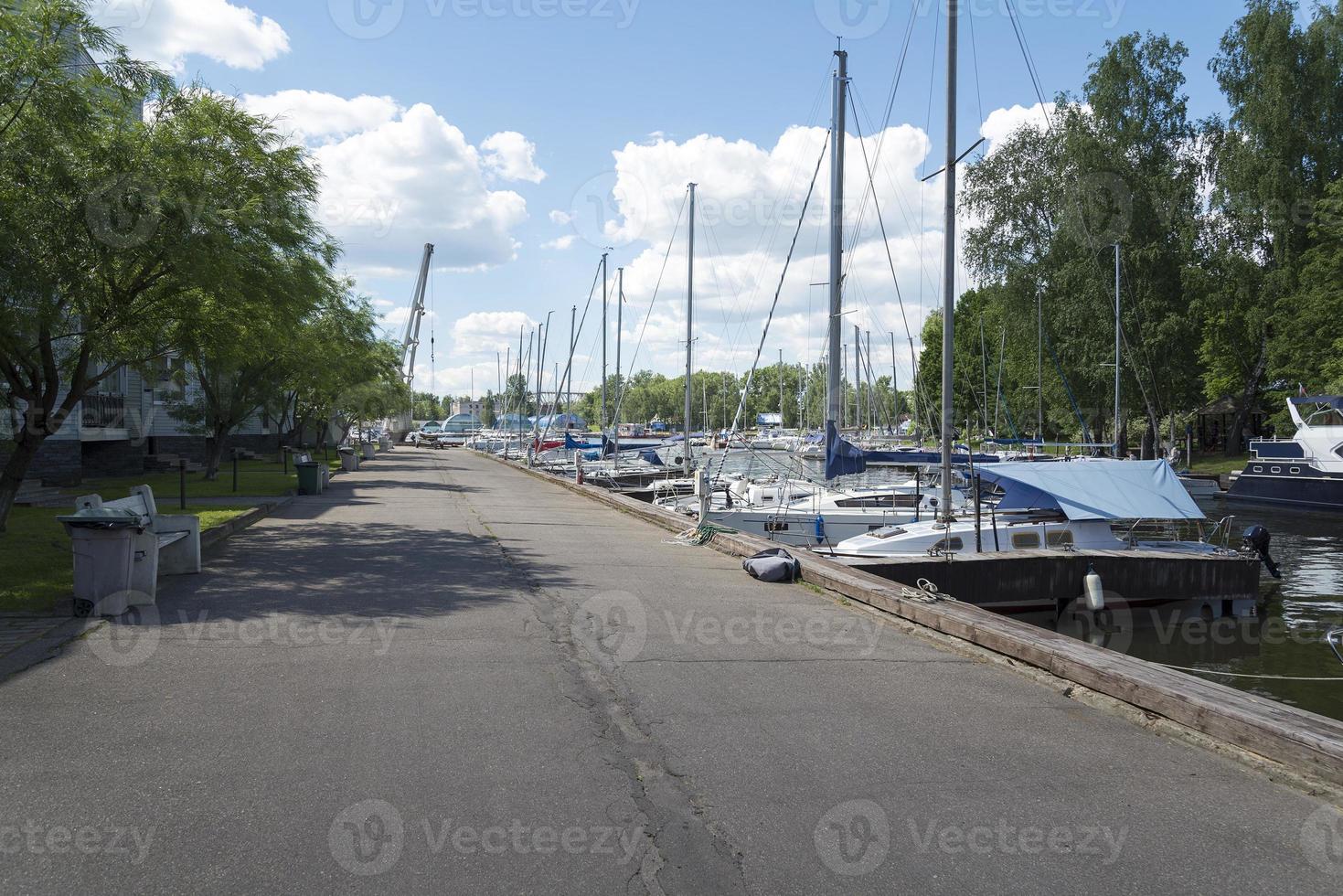 Many sailing yachts are on the pier. photo