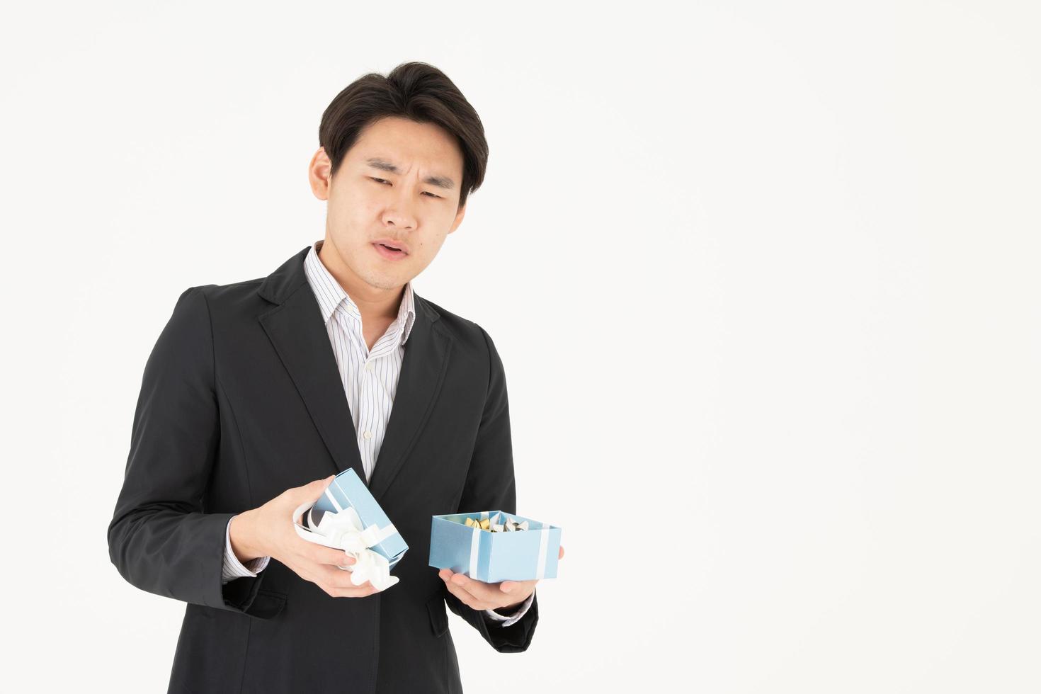 Asian businessmen and their expressions when opening gift boxes photo