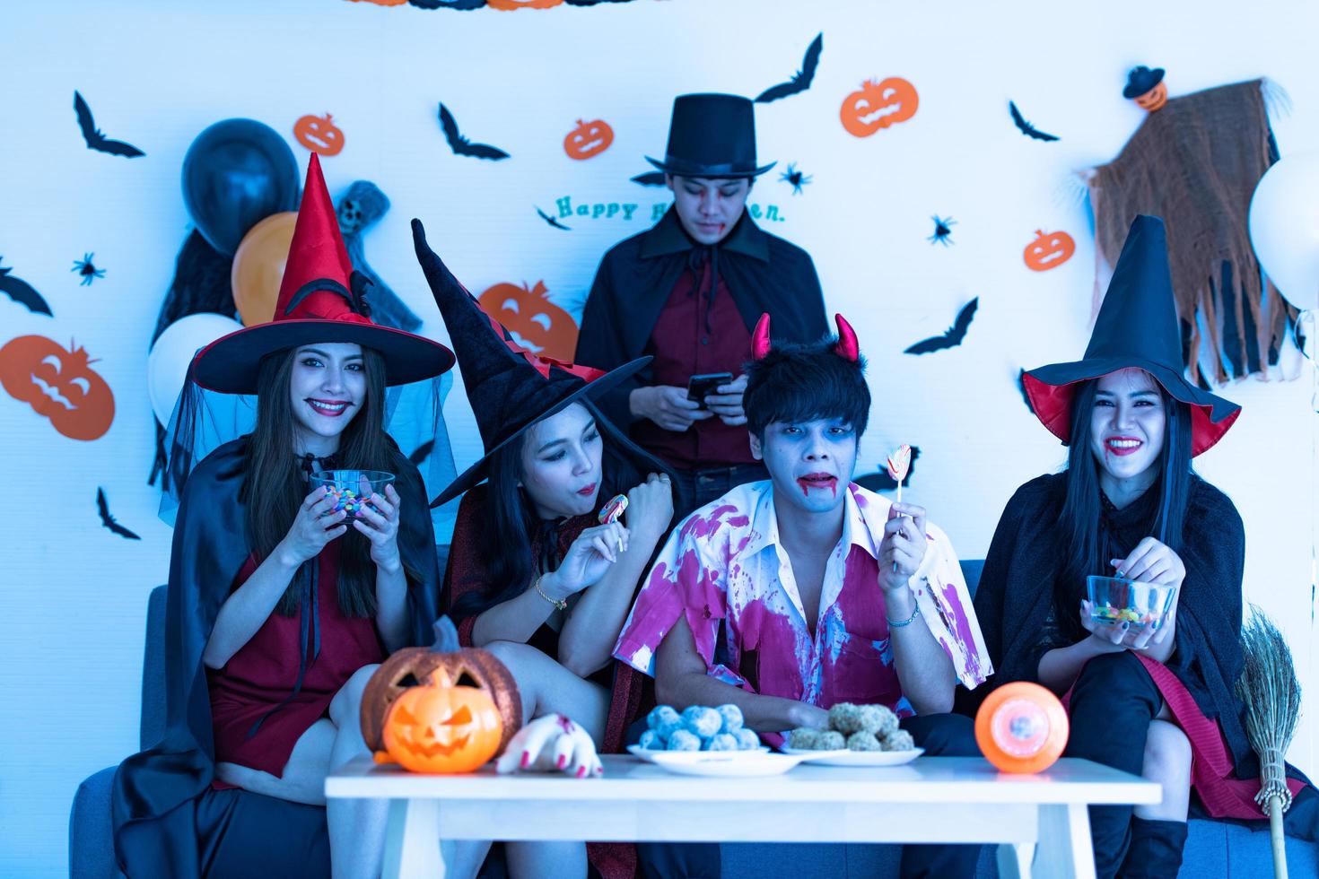 Asian young people in costumes attend celebrate at Halloween party photo