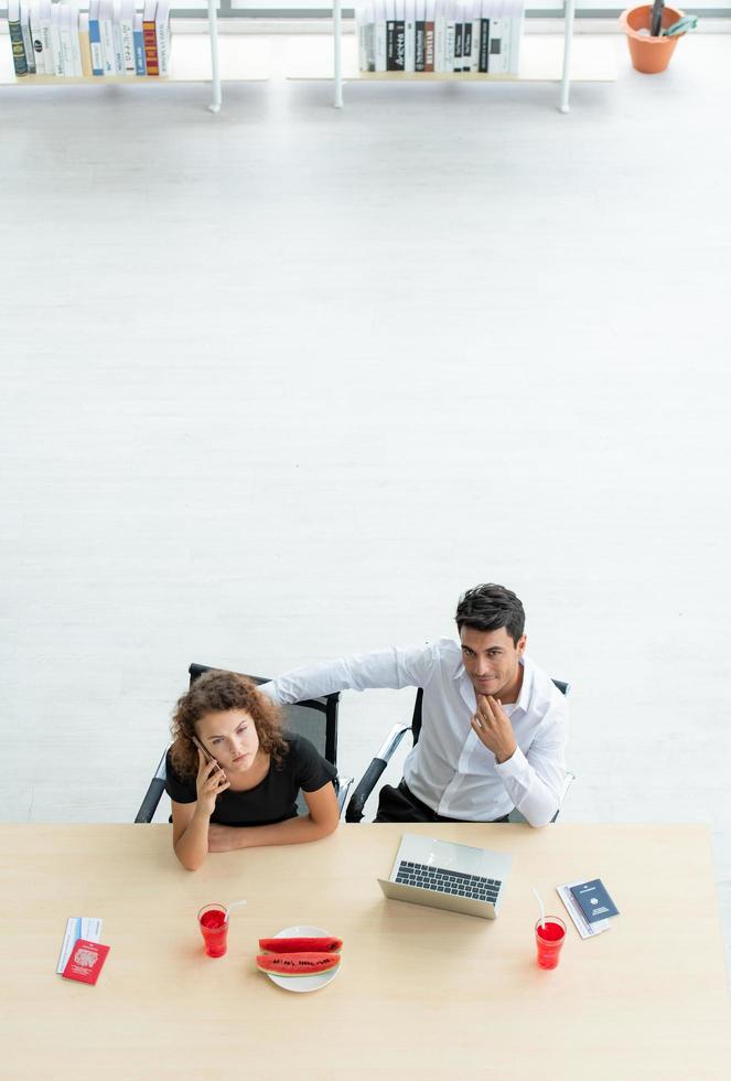 Two office workers searching for tourist attractions photo