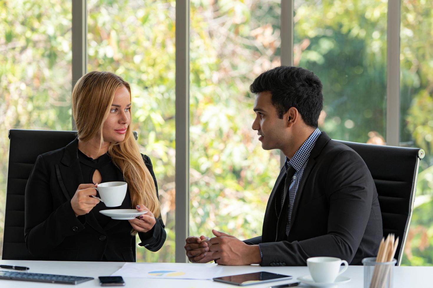 Businessmen and women analyze data and consult various issues photo