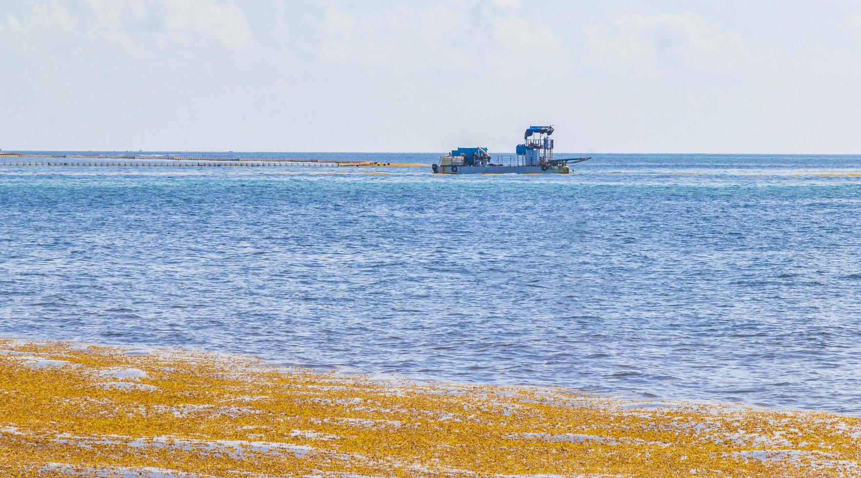 Boats yachts red seaweed sargazo beach Playa del Carmen Mexico. photo