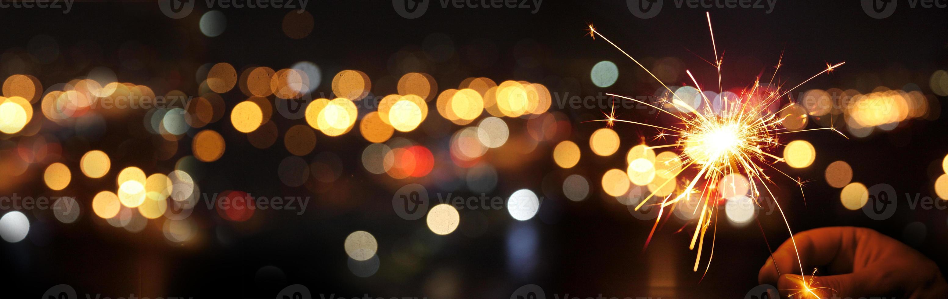 Happy New Year background with glowing sparklers. photo