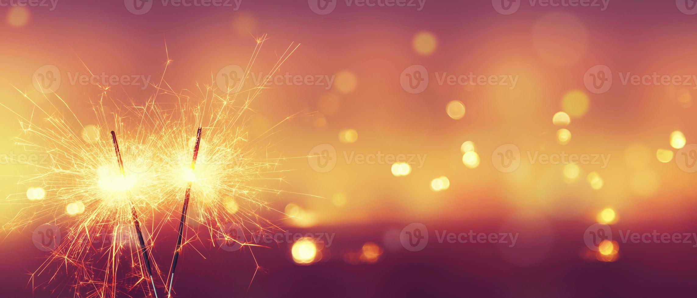 Happy New Year background with glowing sparklers. 5001231 Stock Photo