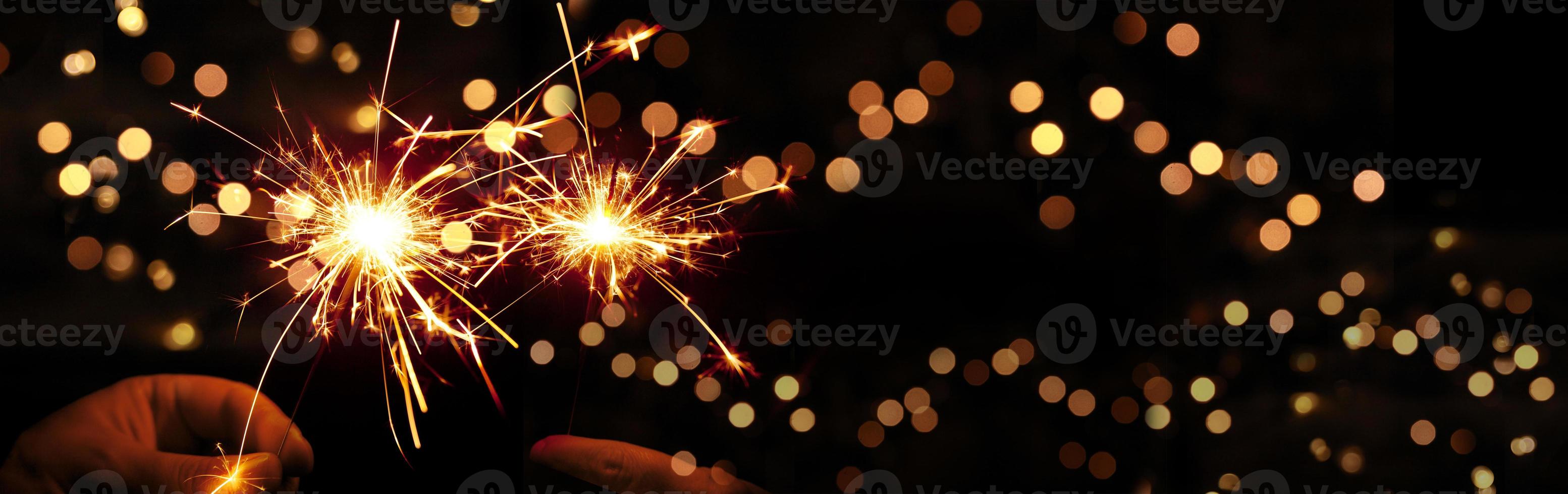 Happy New Year background with glowing sparklers. photo