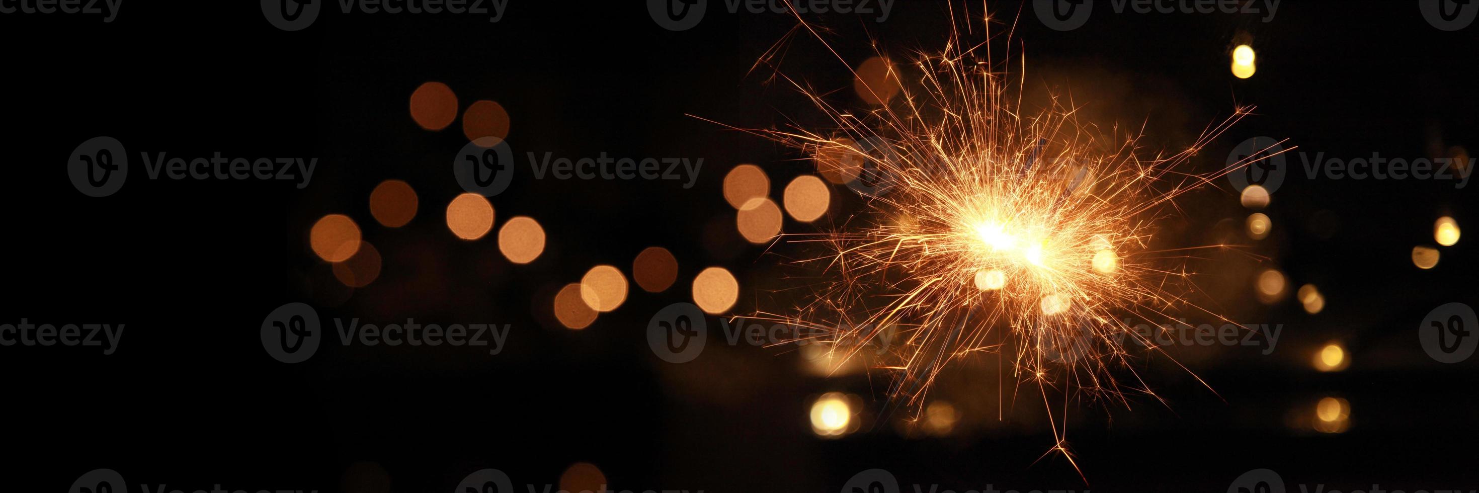 Happy New Year background with glowing sparklers. photo