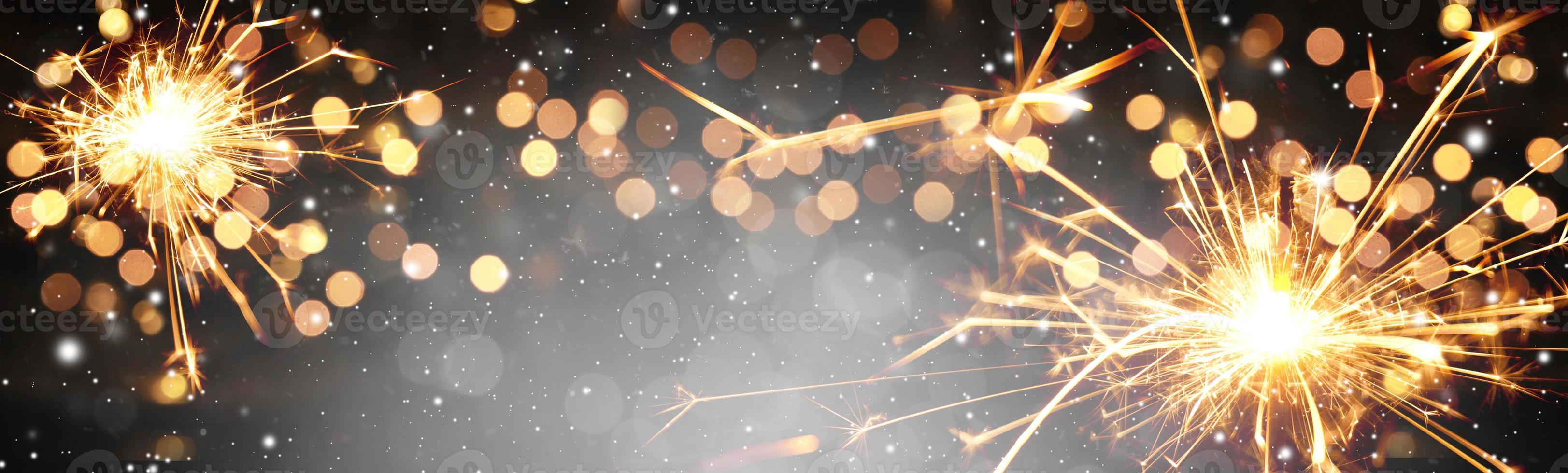 Happy New Year background with glowing sparklers. photo