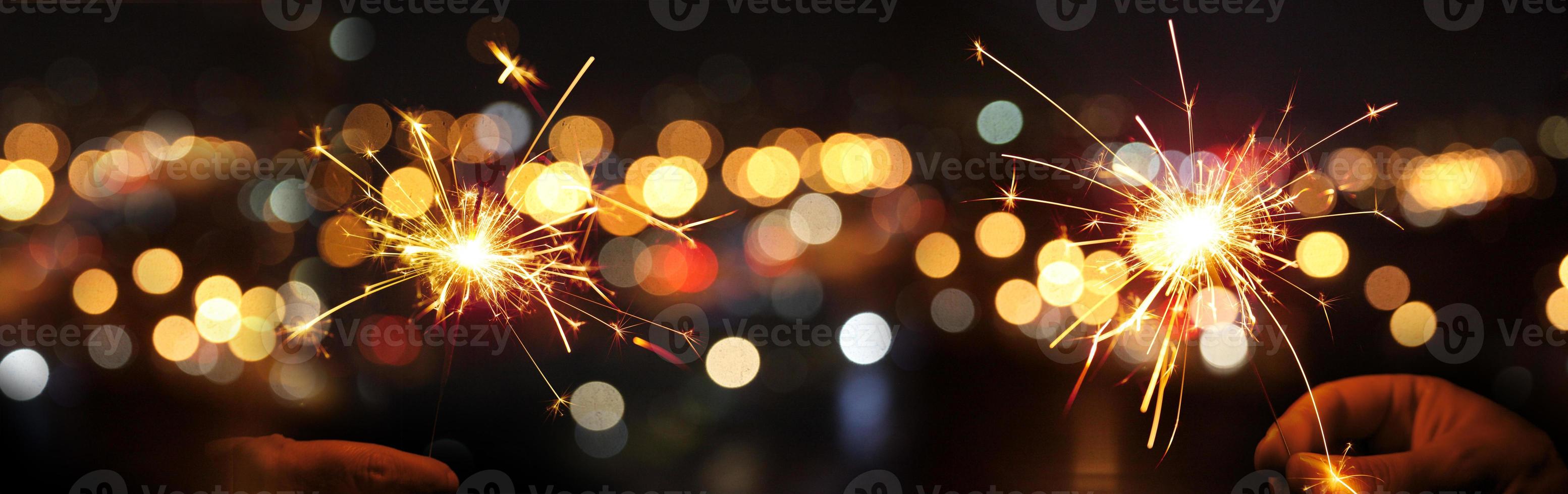 Happy New Year background with glowing sparklers. photo