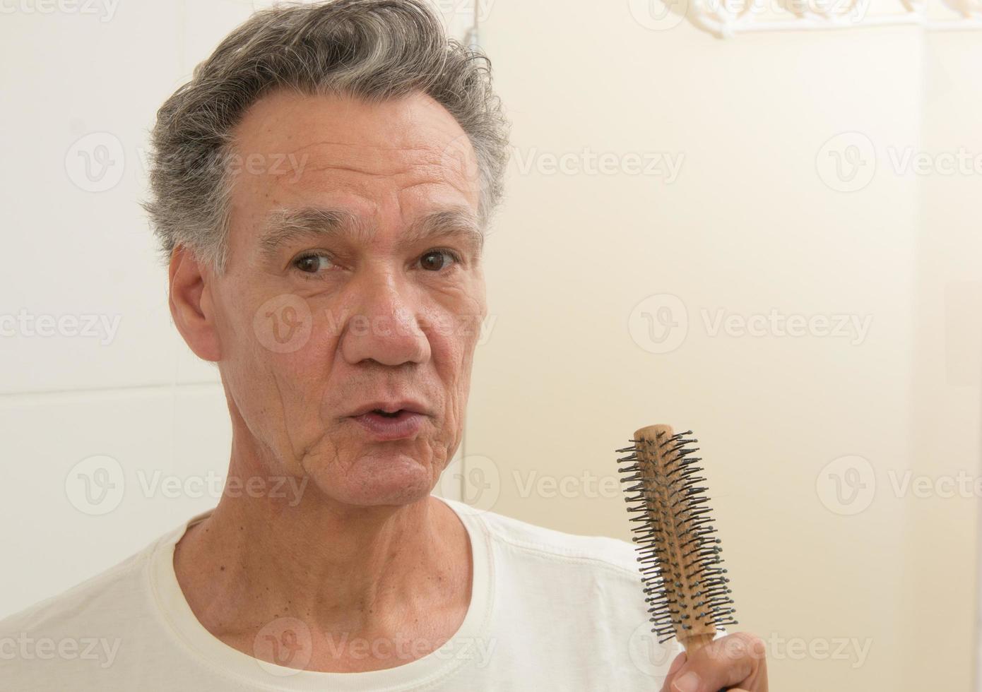Mature Man Brushing an Combing his Hair photo
