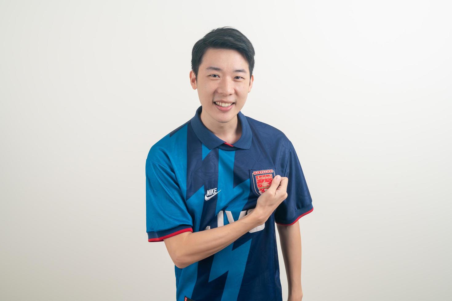 Bangkok, THAILAND - Nov 27, 2021 - Young Asian man wearing Arsenal shirt with white background. photo