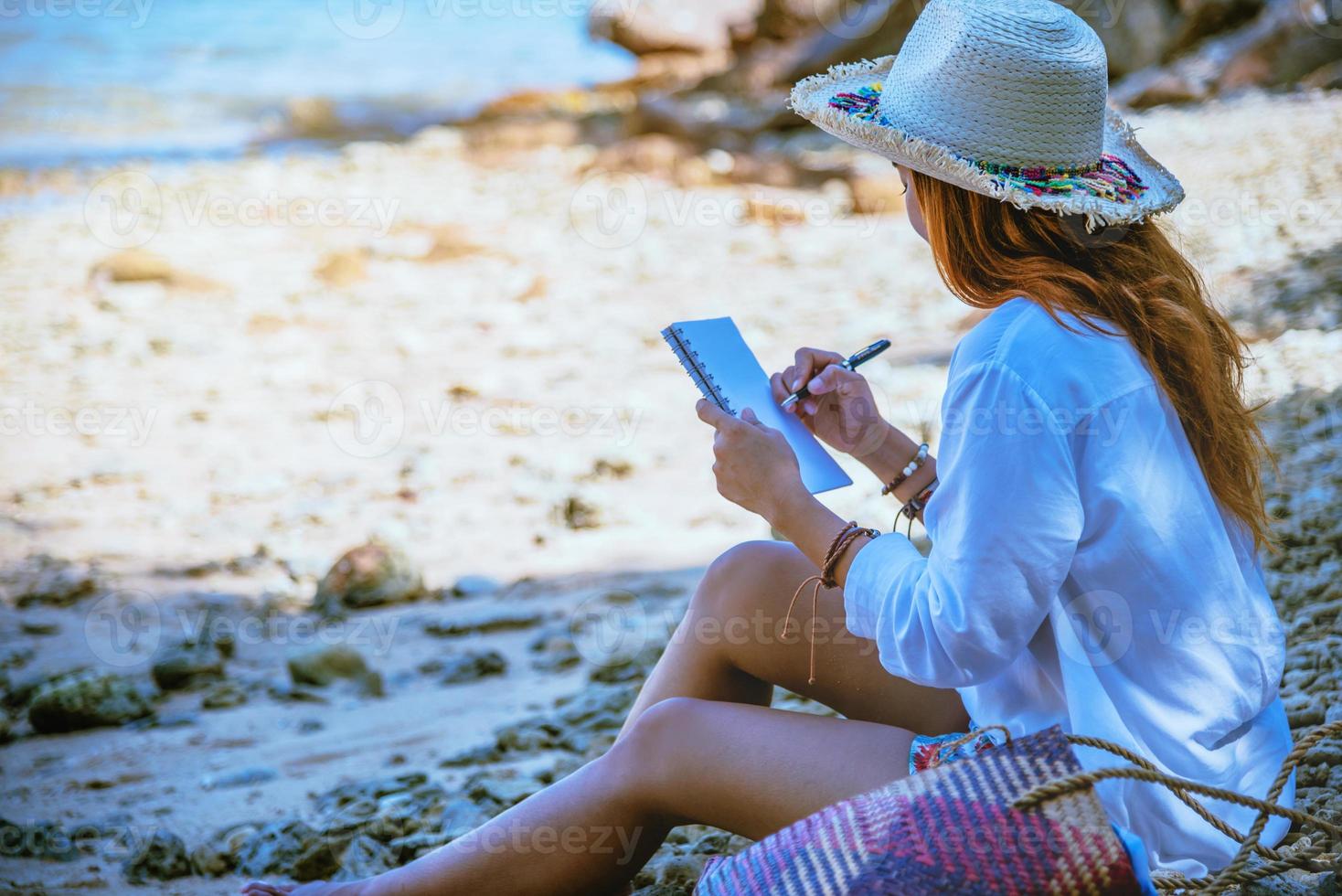 Asian woman travel nature. Travel relax. Study read a book. Nature Education Write a note. On the beach. In the summer. Thailand photo