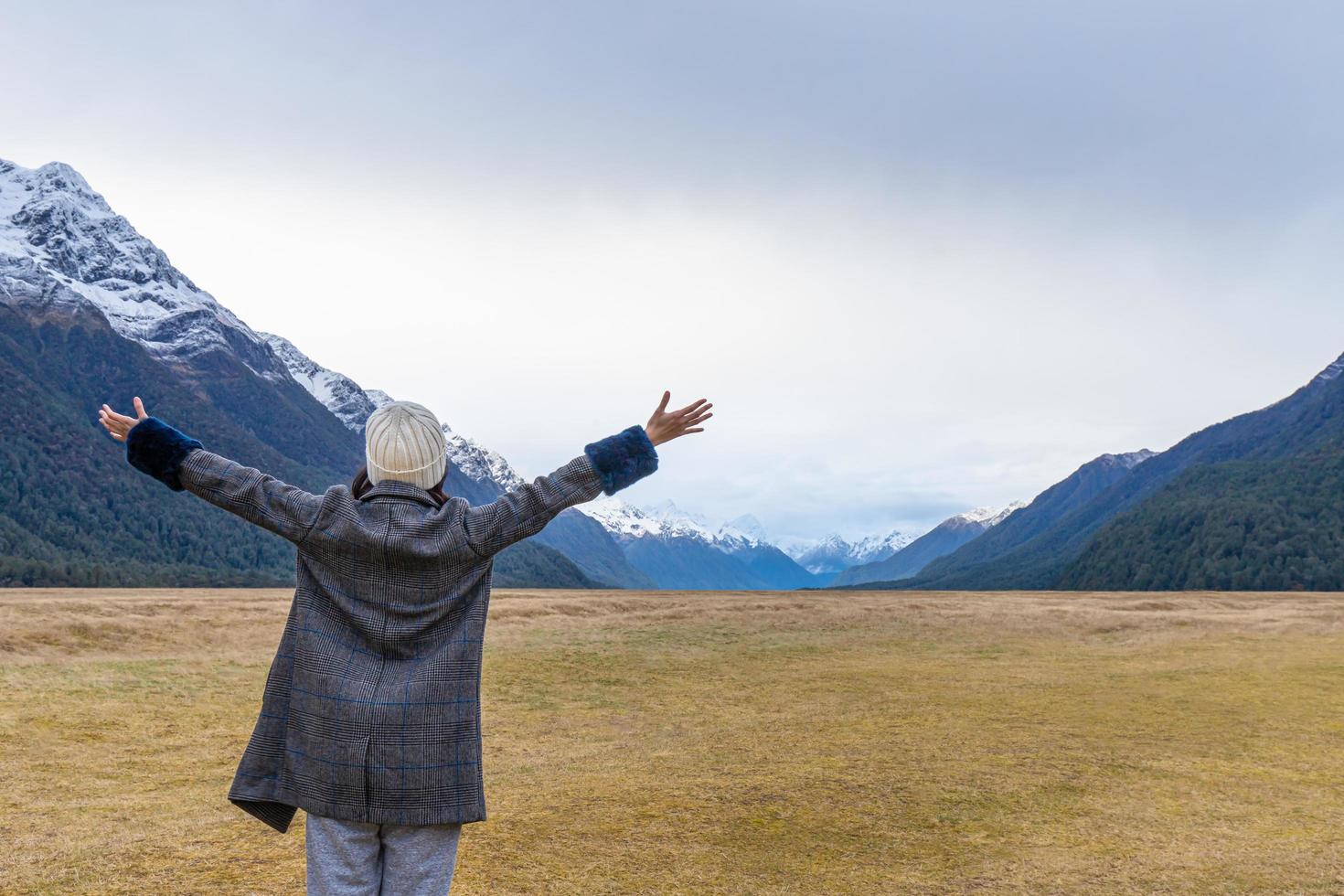 Young Asian traveler celebrating success at Eglinton Valley, Te anua, South Island, New Zealand photo