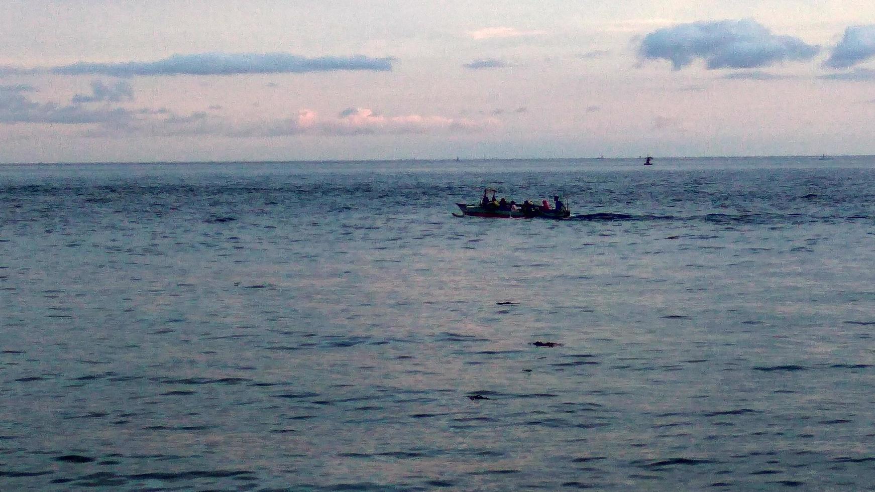 a boat in the middle of the sea. boat carrying tourists photo