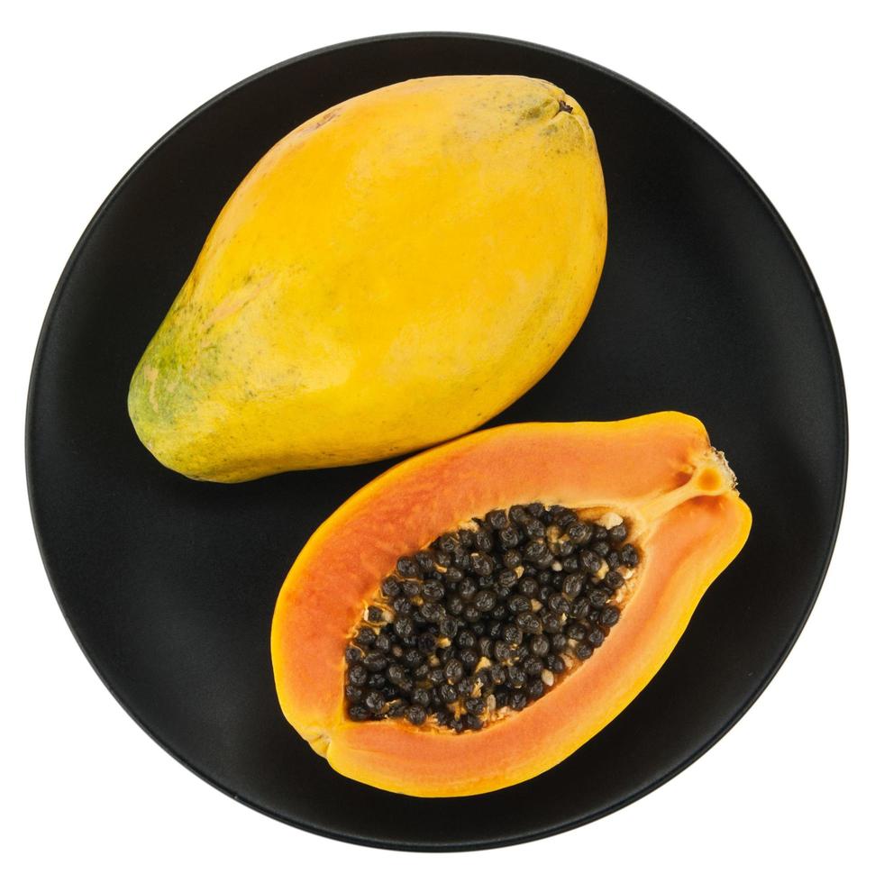 Papaya on white plate, black background. photo