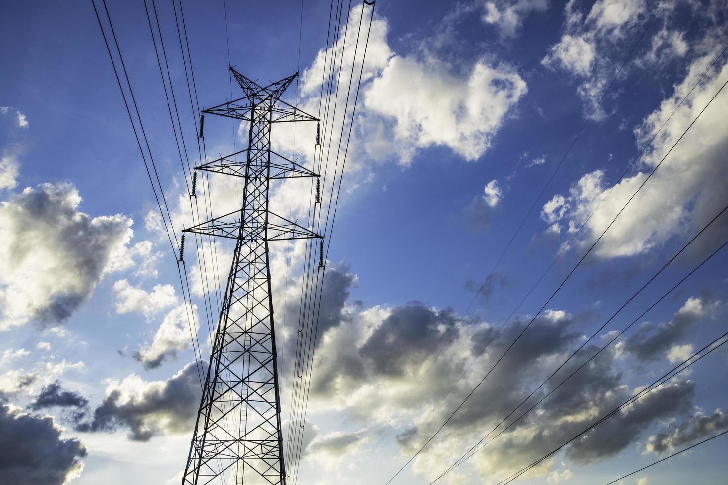 Sky high voltage pylon clouds. photo