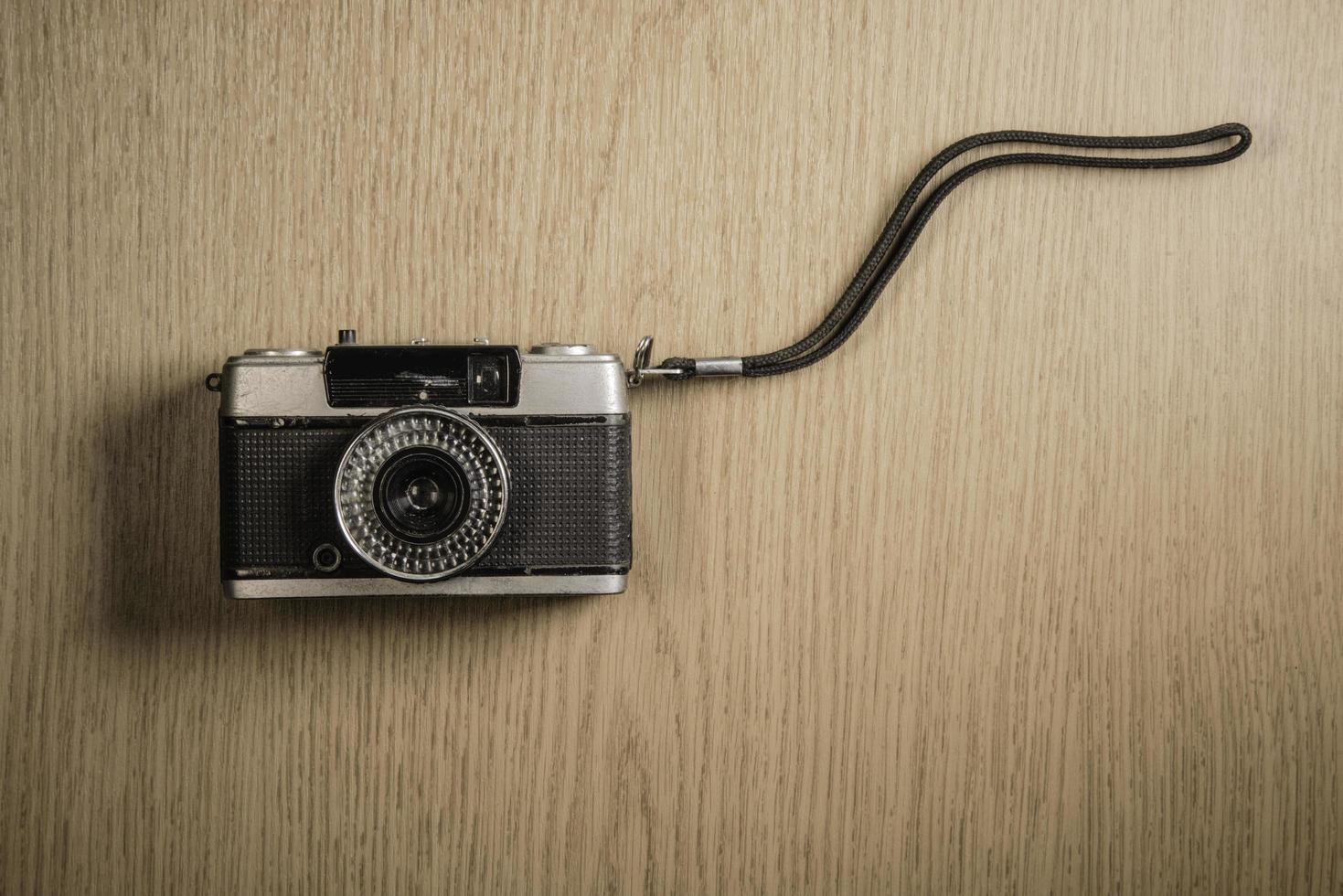 top view of retro camera on wooden table photo