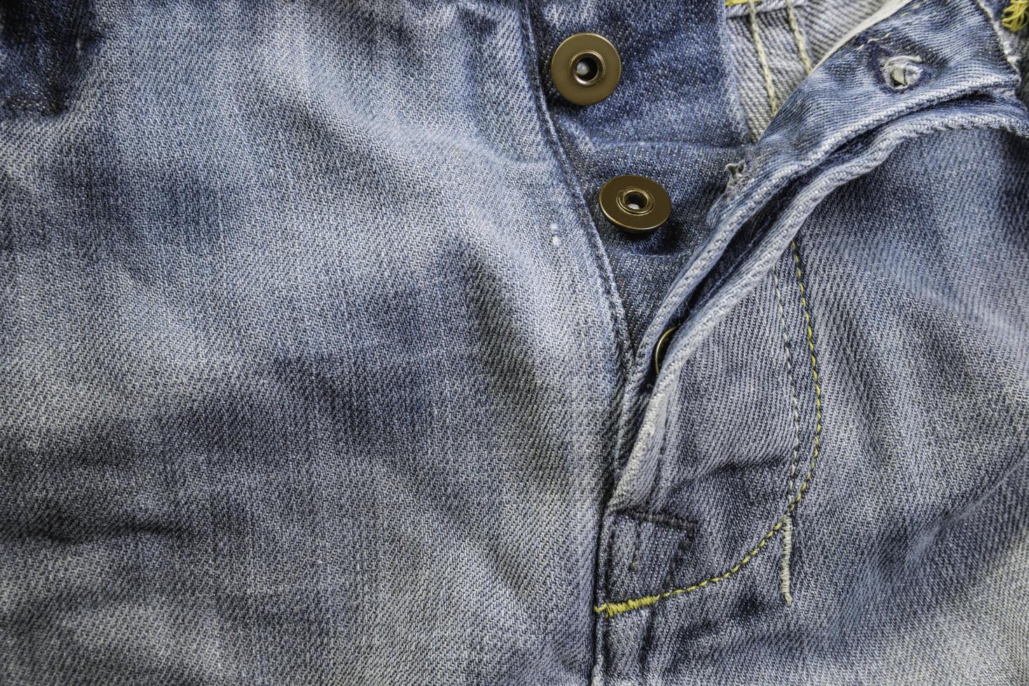 Old grunge vintage denim jeans. Stitched texture denim jeans background of jeans fashion design. photo