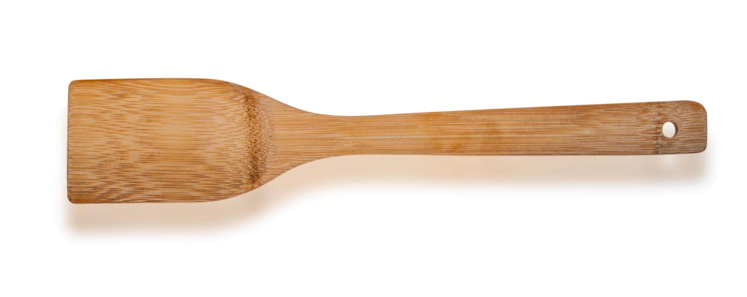 Wooden kitchen spatula isolated on white photo