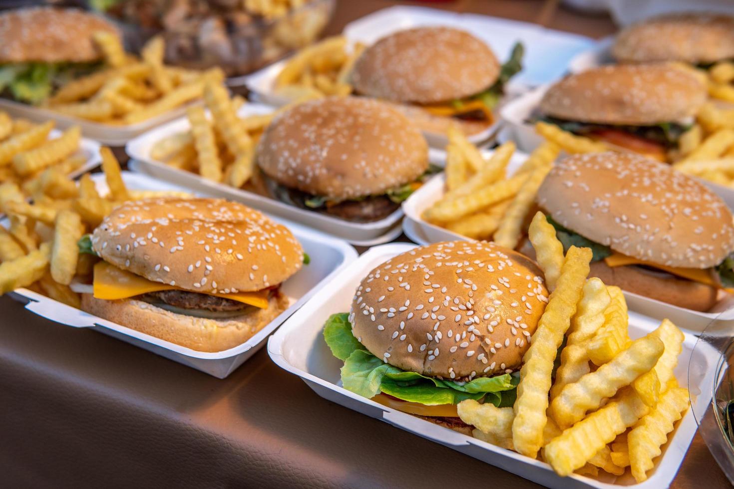 Hamburguesa con queso y papas fritas para la venta en la calle foto