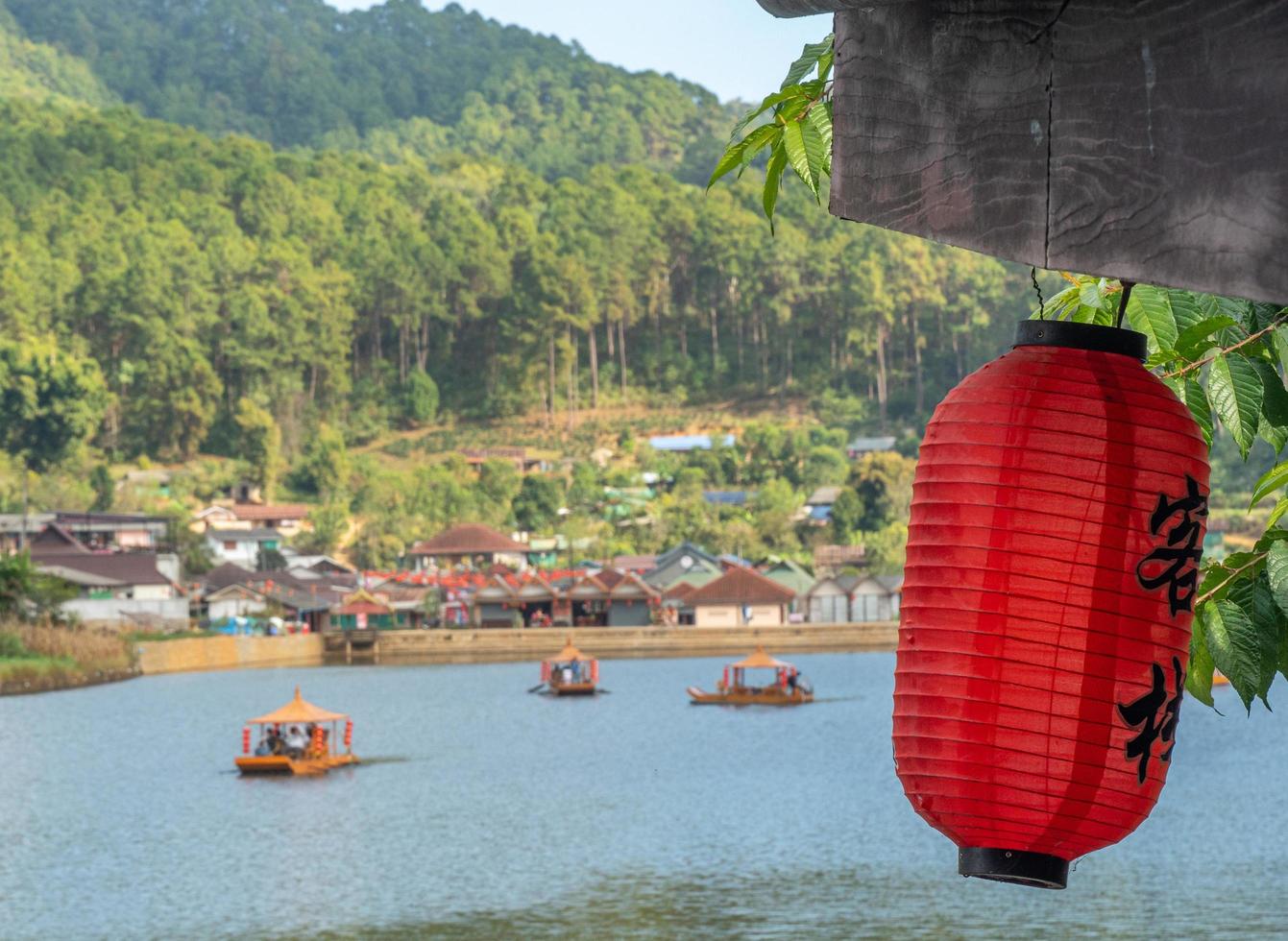 Chinese lanterns and boats in lake with sunset photo