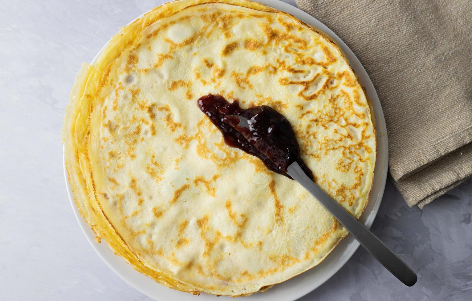 Crepes, French-style pancakes. Wrapped with plum jam. photo