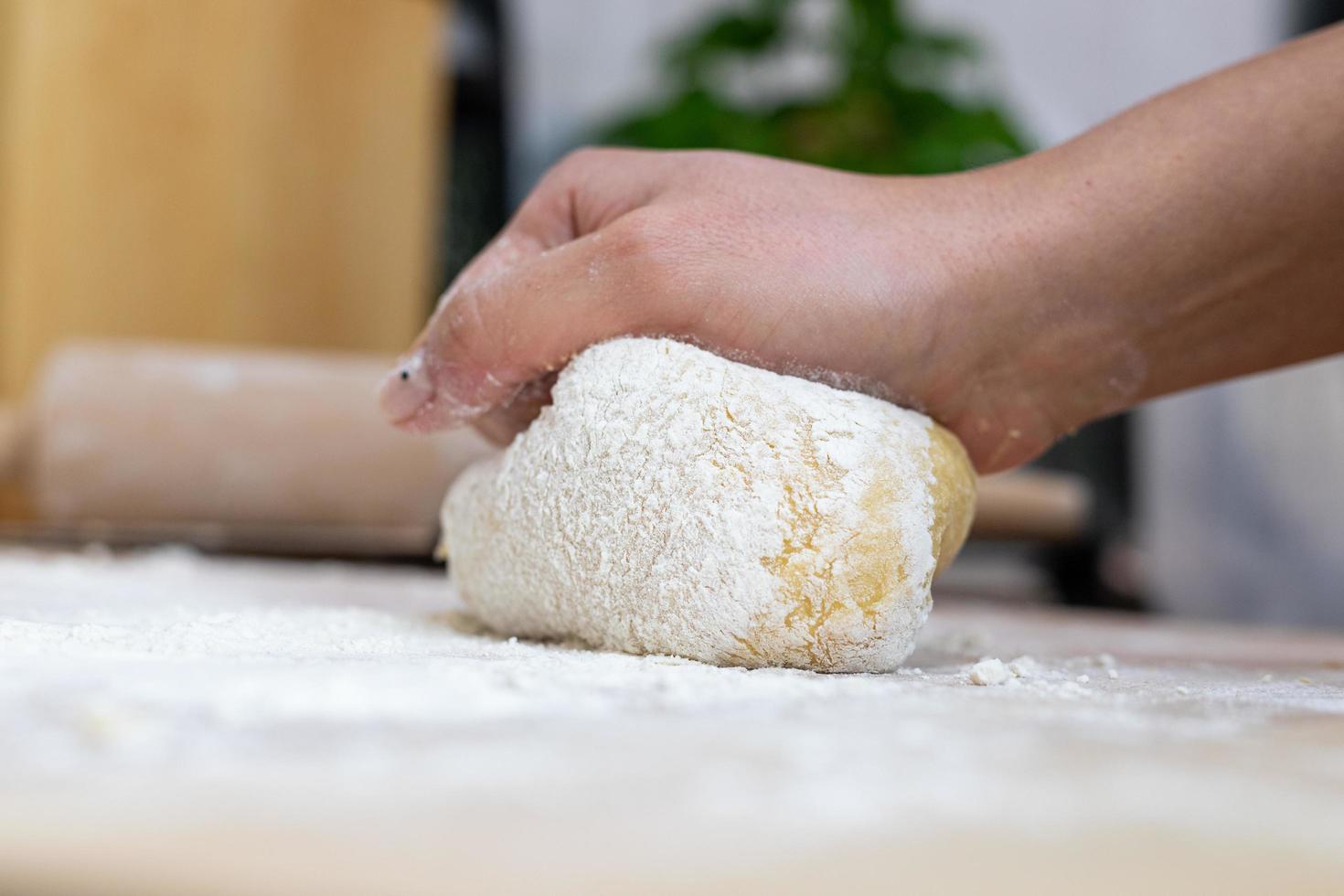 A person kneading the dough for homemade pasta. photo