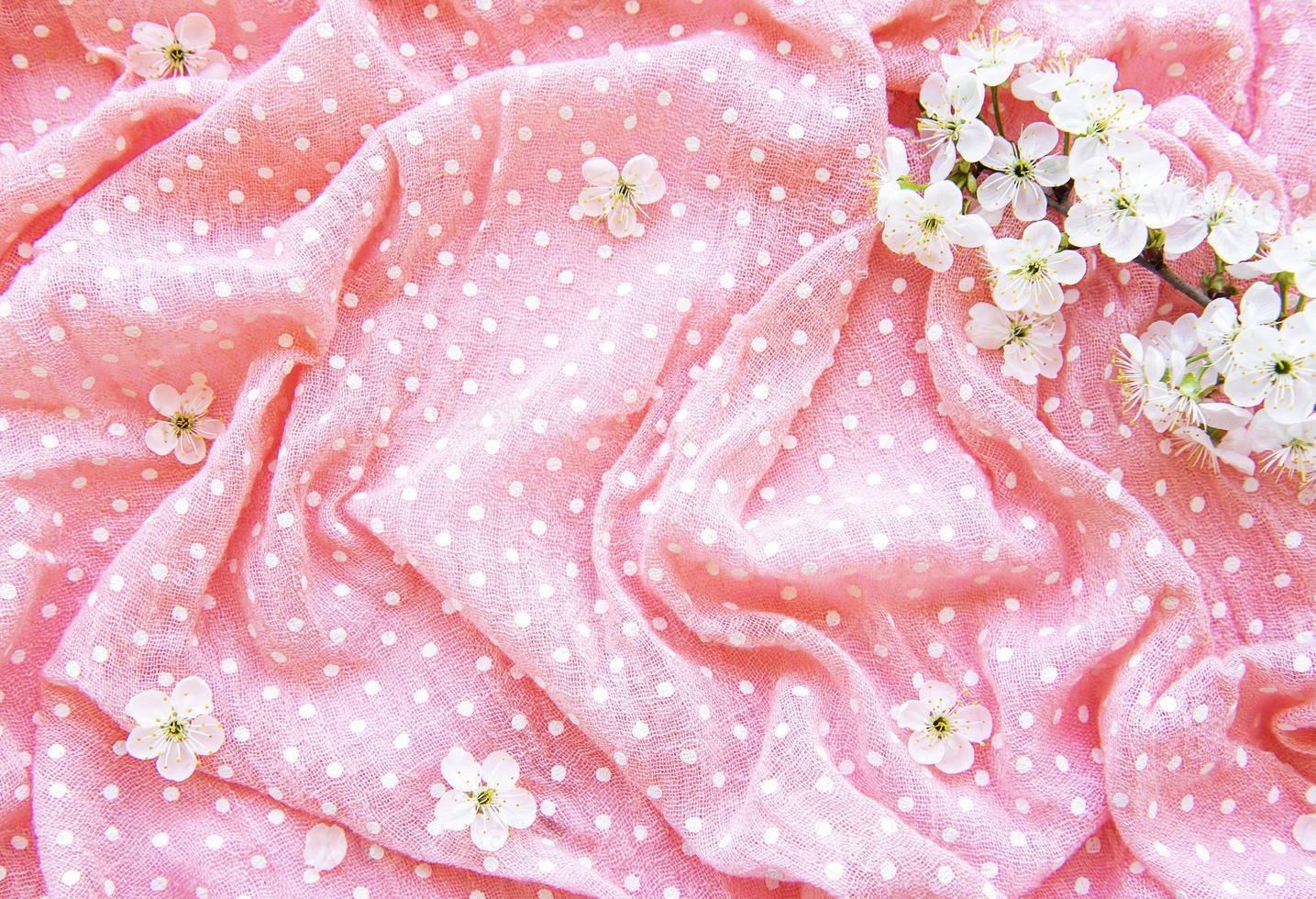 Polka dot pink and white fabric and spring blossom photo