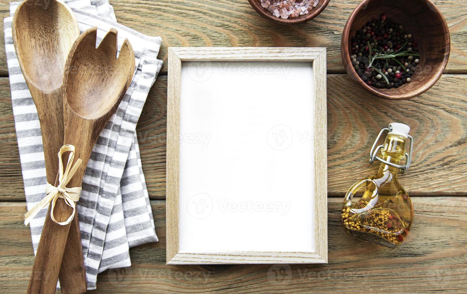 Old wooden kitchen utensils and spices with frame as a border photo