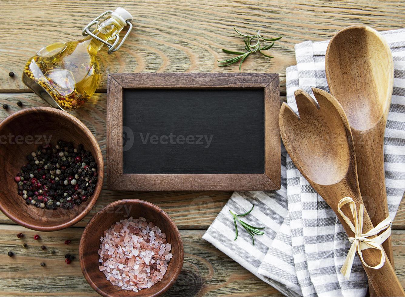 Empty chalk board and kitchen utensils photo