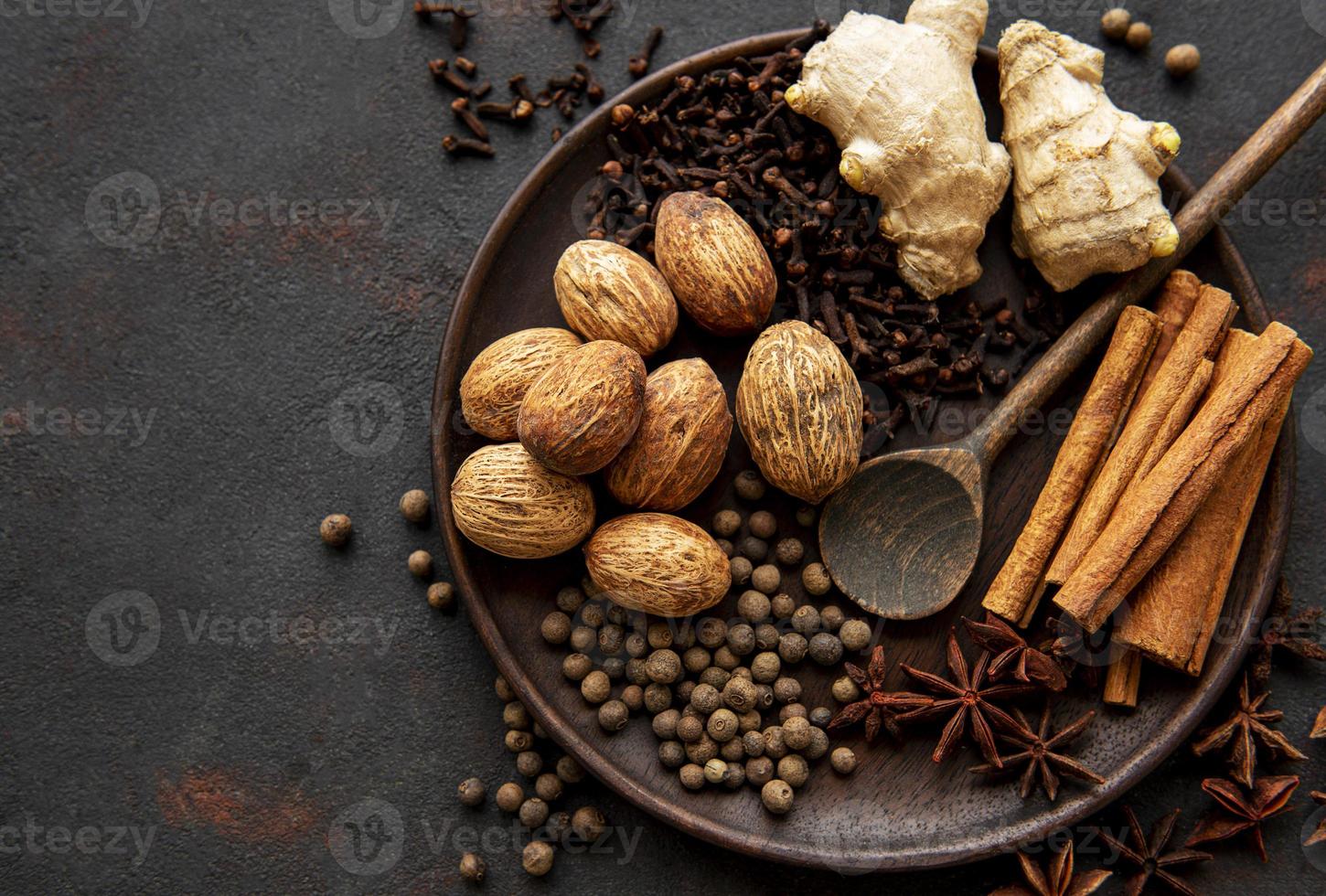 Gingerbread spices on slate - star anise, cinnamon, cloves, nutmeg, ginger, cardamom, black pepper photo