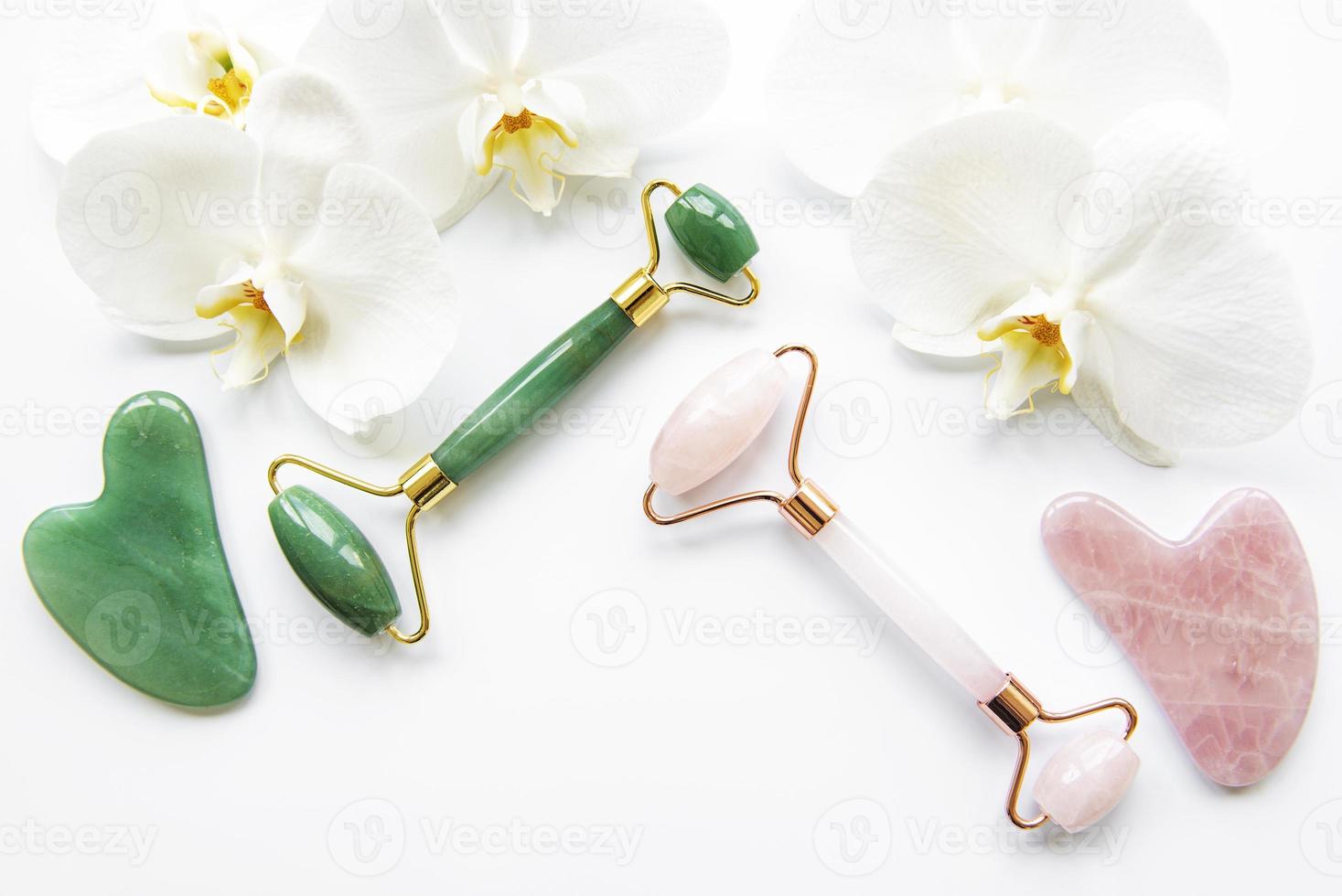 Face massage jade rollers on white background photo