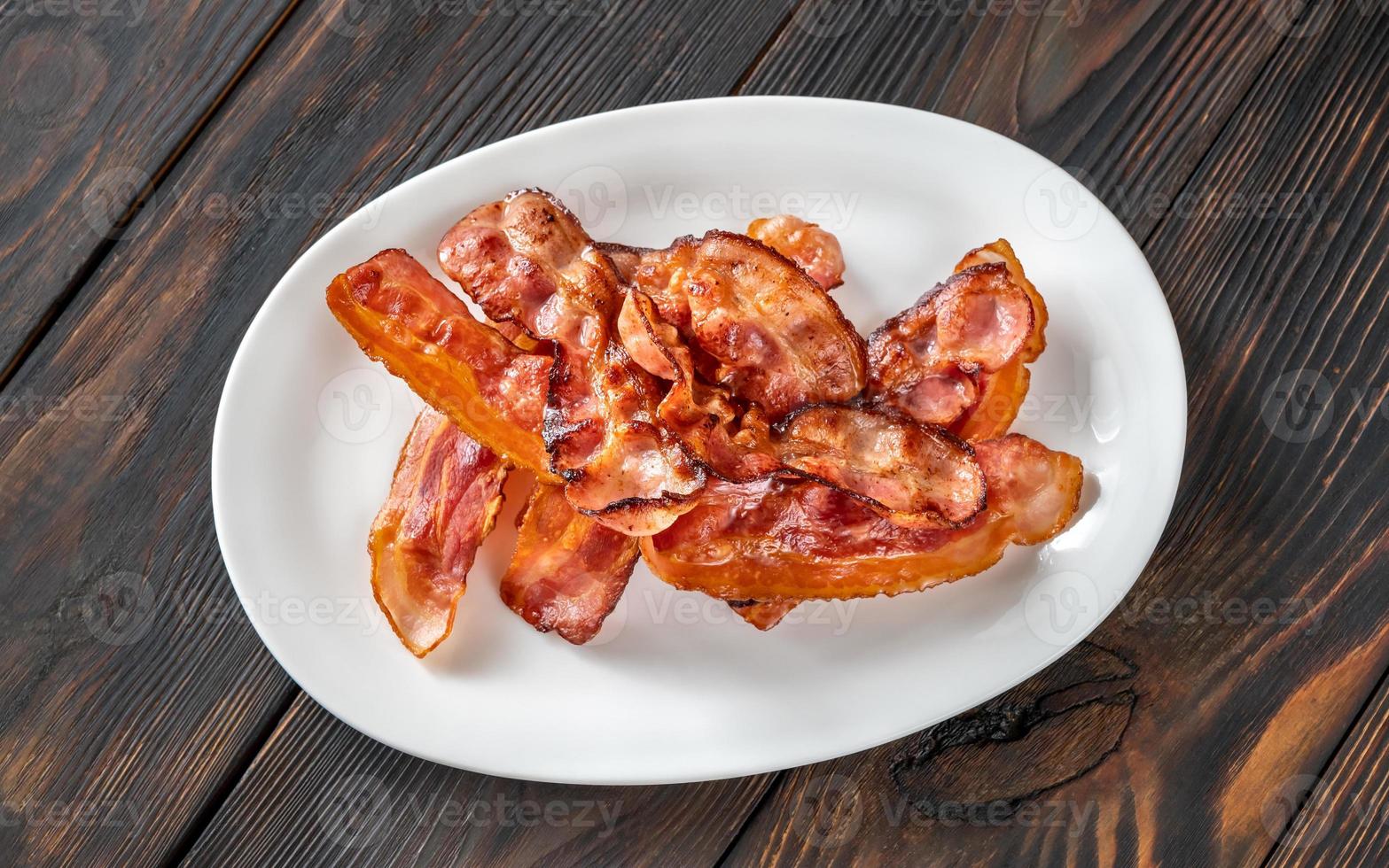 Fried bacon on the serving plate photo