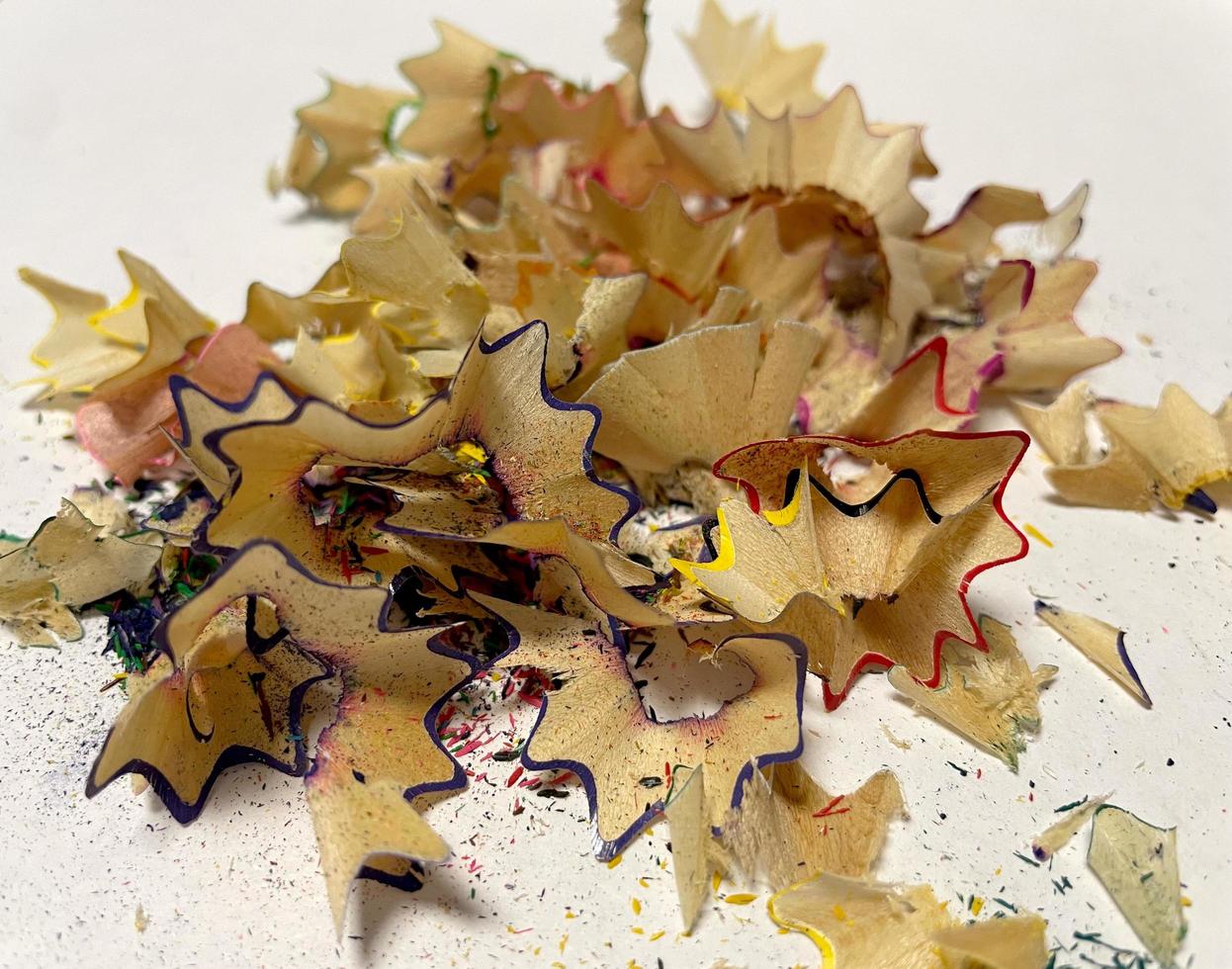 Set of colored pencil shavings on a white background photo