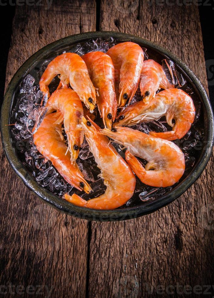 Camarones langostinos en hielo vender en el mercado foto